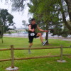 Jason Havelka, a guy I ran with part of the way, clears the last fence right before the finish line. This fence was one of several obstacles on the course.