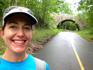 An iPhone selfie on the main road to the park headquarters, showing one of the many stone bridges.