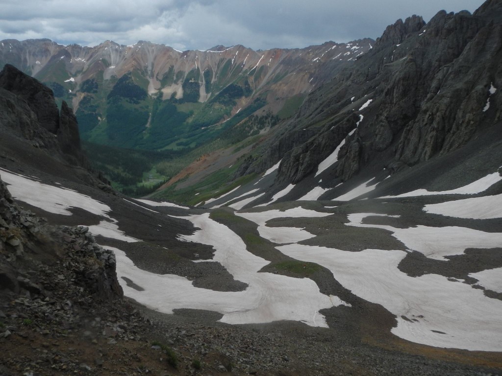 Remnants of storm clouds over Oscar Pass as seen from Grant Swamp Pass. These are the two passes leading to Telluride. Hardrock runners go over multiple mountain passes like this. Photo by Chihping Fu
