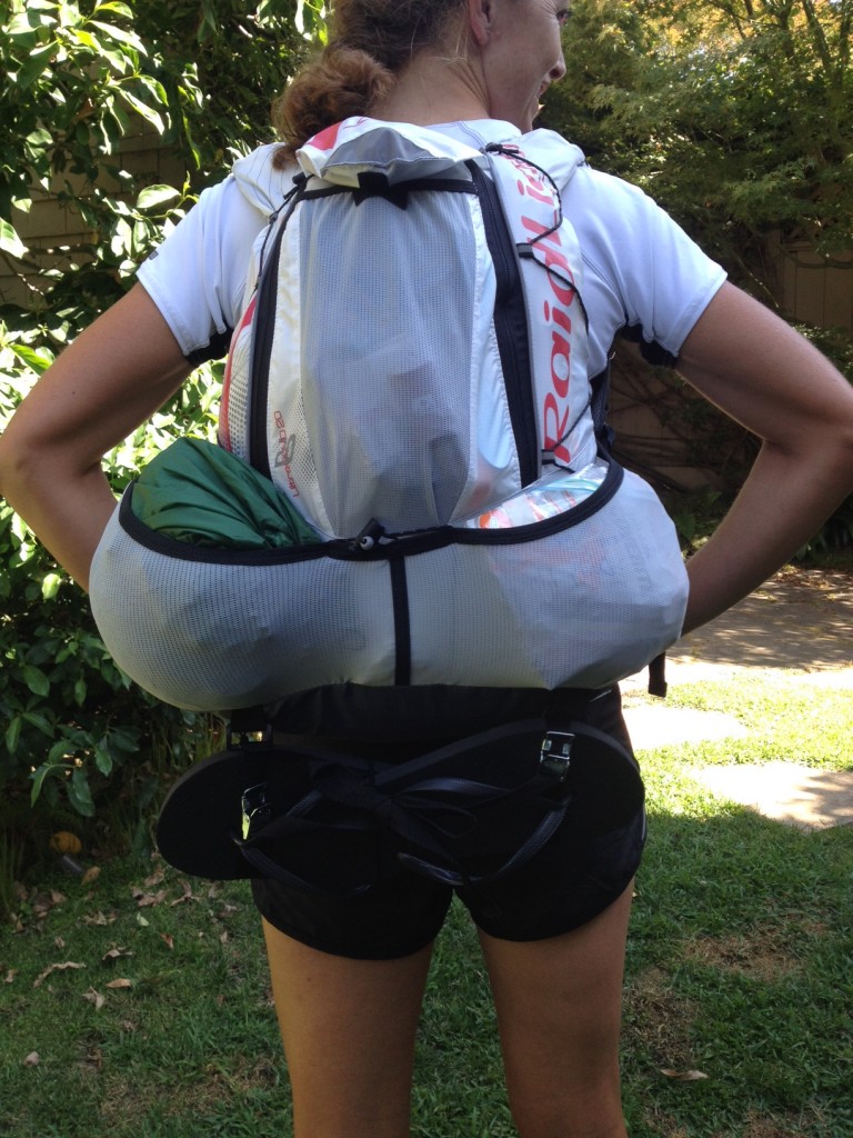 The green sack in the left outer pocket is a waterproof bag holding my down jacket and inflatable sleeping bag; the bag in the pocket on the right holds my meal for the first night. By Day 2, I hope, I'll be able to fit my flip-flops on the inside or the outer pocket so they won't need to be strapped below.