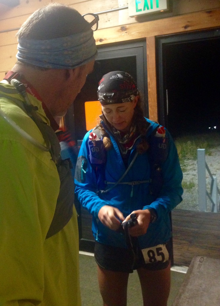 Jenn took this photo of Chris and me heading out of Brighton Aid Station around 5 a.m., facing the final one-fourth of the course. I was not a happy camper.