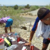 Jamil, doubled over wearing a purple sweatshirt from a drop bag; and Schulyer, hunched at the aid station table, trying to choke down some expired snacks during "Mystery Drop Bag Challenge."